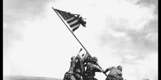 soldiers raising the american flag on iwo