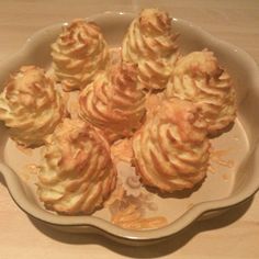 a white plate topped with lots of food on top of a wooden table