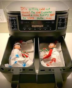 two baby dolls are placed in an automatic food cooker