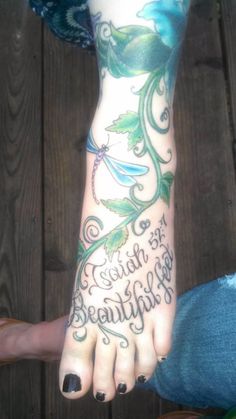 a woman's foot with tattoos and words on it