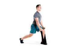 a man is doing an exercise on a treadmill while holding his leg up to the side