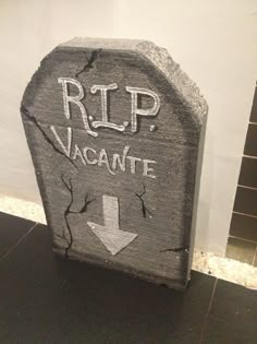 a rock with the words rip vacante painted on it and an arrow pointing up