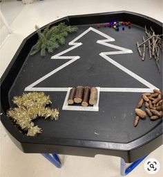 a black table topped with lots of different types of food and decorations on top of it