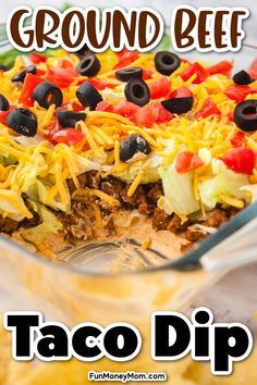 a casserole dish filled with taco dip and black olives