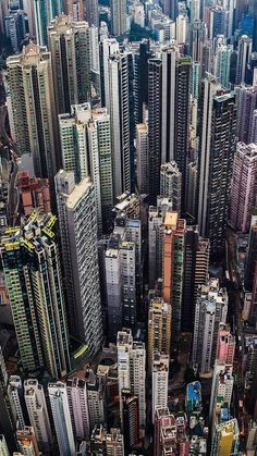 an aerial view of many tall buildings in a city