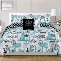 a bed in a room with a blue and white comforter on top of it