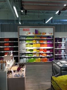 the interior of a store with lots of items on shelves and in bins for sale