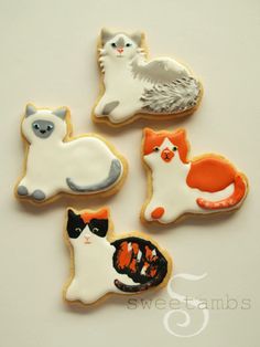 four decorated cookies with cats and kittens on them