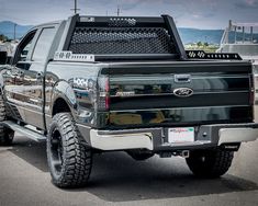 a black truck parked in a parking lot