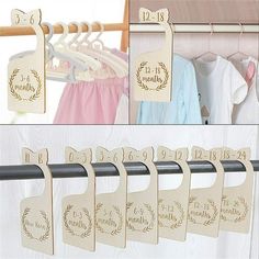 wooden clothes hangers with personalized names and numbers on them, hanging from a rail