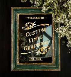 a welcome sign is hanging on the wall in front of some white flowers and greenery