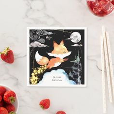 there is a card with a fox on it and some strawberries next to it