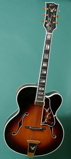 an acoustic guitar is shown against a blue background with its neck and frets removed