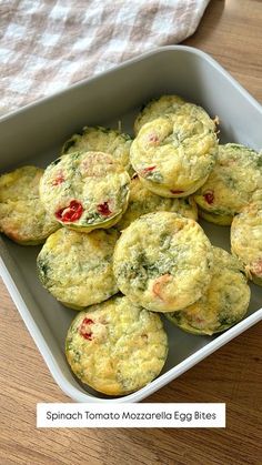 several small muffins in a white dish on a wooden table