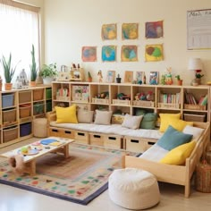 a living room filled with lots of furniture and bookshelves next to a window