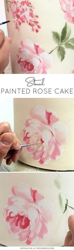 someone is painting flowers on a cake with white frosting and pink icing,