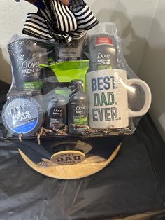 a man's gift basket with personal care items on top of a black table