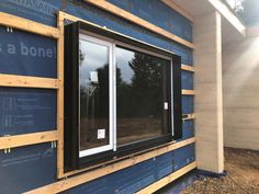 the side of a house being built with windows and siding on it's sides