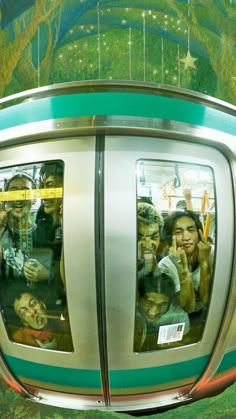 people are taking pictures in the mirror of a train