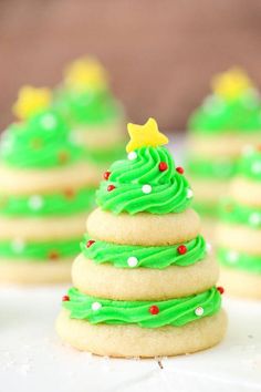 green frosted christmas tree cookies on a white plate