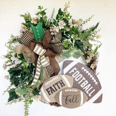 a wreath with footballs and greenery on it