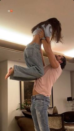 a man holding up a woman in the air