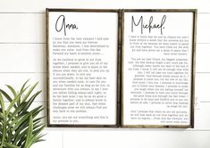 two framed posters with the words, mom and me on them next to a potted plant