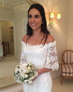 a woman in a white dress holding a bouquet