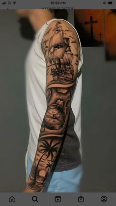 a man's arm with a ship and compass tattoo on it