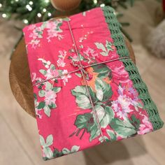 a wrapped present sitting on top of a wooden table