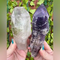 two different types of crystals being held in their hands