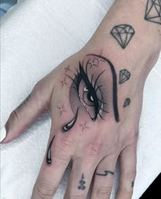 a hand with an elephant tattoo on it's left palm and diamond tattoos on the other hand