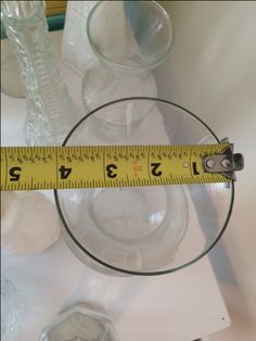 a measuring tape on top of a glass bowl