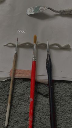 three different types of paintbrushes on top of a piece of paper