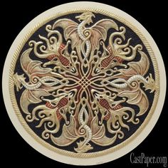 an intricately decorated wooden plate with gold and red accents