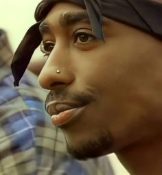 a close up of a person wearing a bandana