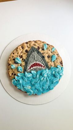 a cookie with blue icing and a shark on it