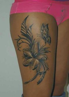 a woman's thigh with flowers and butterflies on it