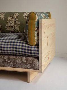 a couch made out of wood and fabric