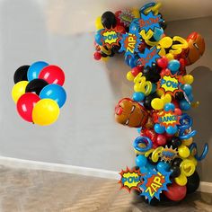 balloons are in the shape of letters and numbers on a balloon column, with an image of mickey mouse