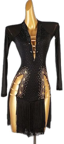 a black and gold dress on a mannequin's torso with fringes