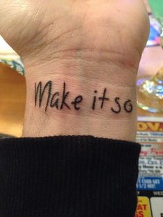 a wrist tattoo with the words make it so written on it