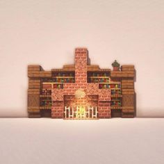 a brick fireplace with candles on it in front of a white wall and some bookshelves