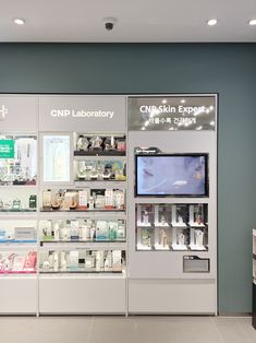 a pharmacy store with an open medicine cabinet in front of the counter and tv on the wall