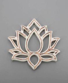 a wooden brooch with a lotus design on it