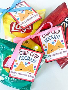 four bags of chips with ribbons tied around them