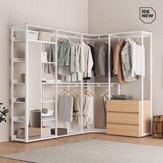 a white closet with clothes hanging on the shelves and drawers in front of it, next to a plant