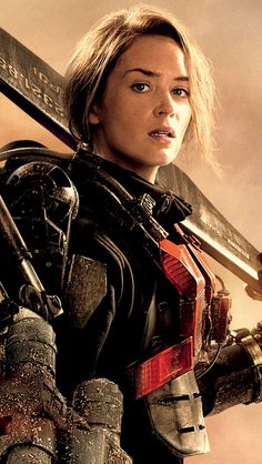 a woman holding two swords in front of a cloudy sky with the words edge of tomorrow written on it