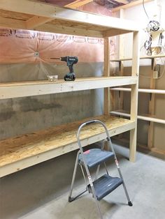 a work bench and ladder in a room under construction