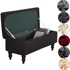 an open suitcase sitting on top of a wooden table next to four different colors of fabric